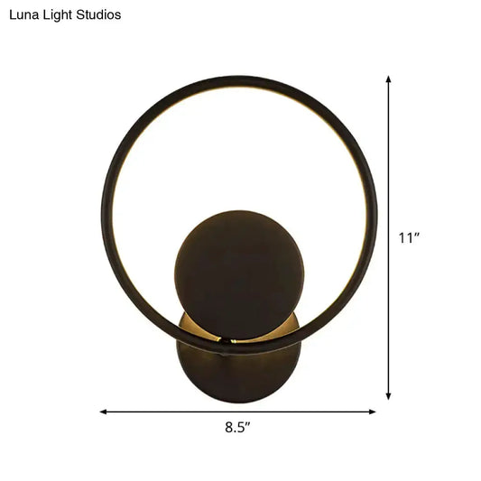 Modern minimalist black halo ring metal wall sconce with warm glow on Tampa Home & Garden Store