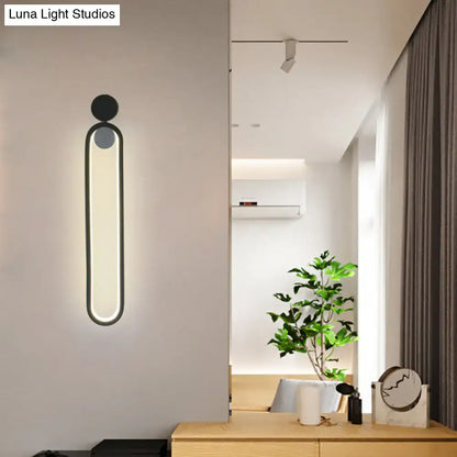 Black adjustable LED sconce by Decorbites with vertical glowing panel in black metal on Tampa Home & Garden Store
