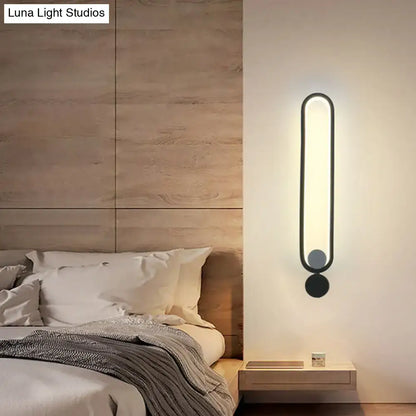 Black adjustable LED wall sconce Decorbites with rounded vertical frame on Tampa Home & Garden Store