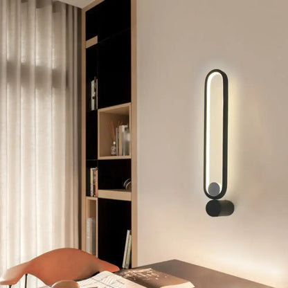 Black adjustable LED wall sconce by Decorbites; matte black metal frame with rounded vertical light on Tampa Home & Garden Store