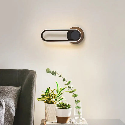 Matte Oval Wall Sconce Decorbites, black oval with circular mount and warm backlight on Tampa Home & Garden Store