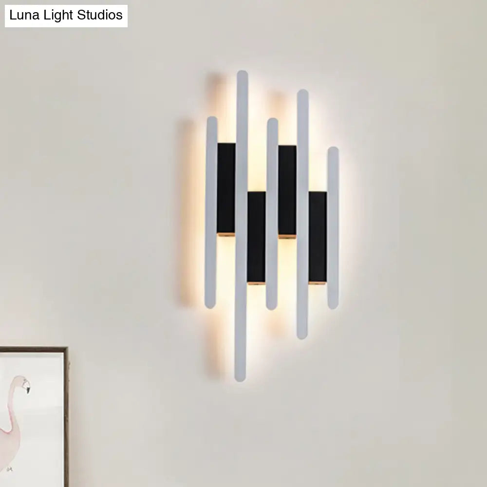 Decorbites white acrylic wall sconce with multi-height vertical rods and warm backlit glow on Tampa Home & Garden Store