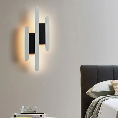 Decorbites white acrylic wall sconce with multi-height vertical bars; warm glow on Tampa Home & Garden Store