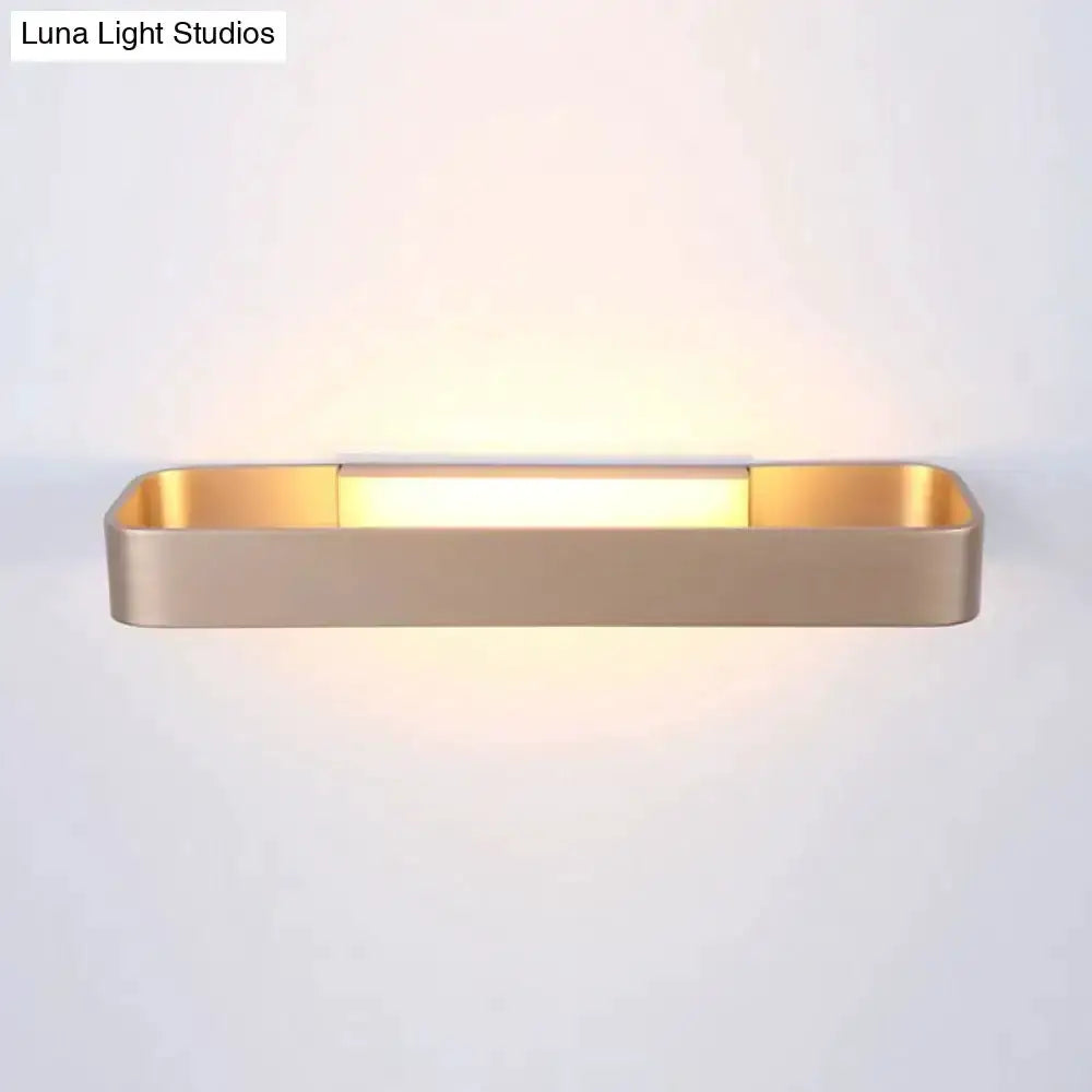 Decorbites modern minimalist rectangular wall lamp with a warm gold finish emits soft glow on Tampa Home & Garden Store