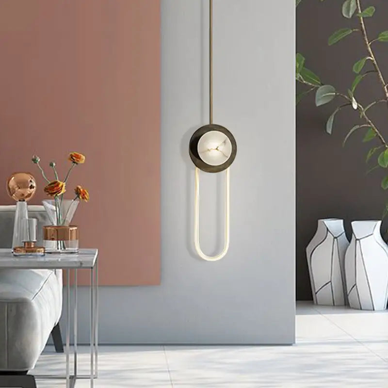 Bronze Oval Wall Lamp by Decorbites with bronze mount and glowing U-shaped light on Tampa Home & Garden Store