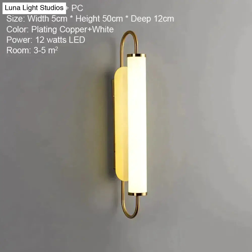 Decorbites gold LED wall lamp with cylindrical frosted shade and curved metal frame for bedroom on Tampa Home & Garden Store