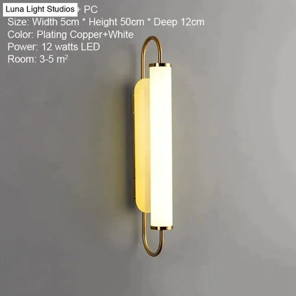 Decorbites gold LED wall lamp with cylindrical frosted shade and curved metal frame for bedroom on Tampa Home & Garden Store