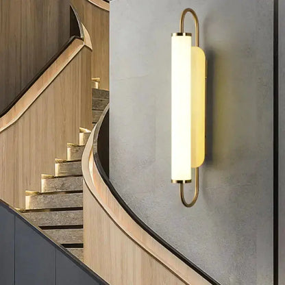 Decorbites gold LED wall lamp cylindrical sconce with brass rings on grey wall on Tampa Home & Garden Store