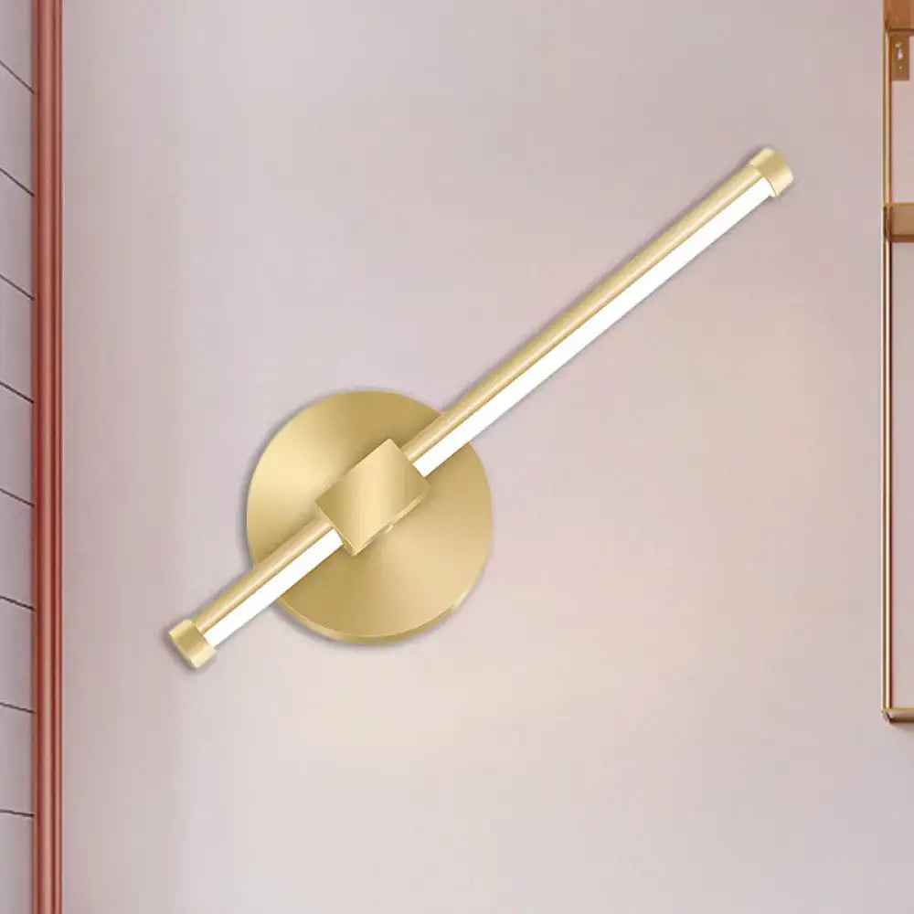 Gold tube wall sconce by Decorbites with round backplate and diagonal gold tube on Tampa Home & Garden Store