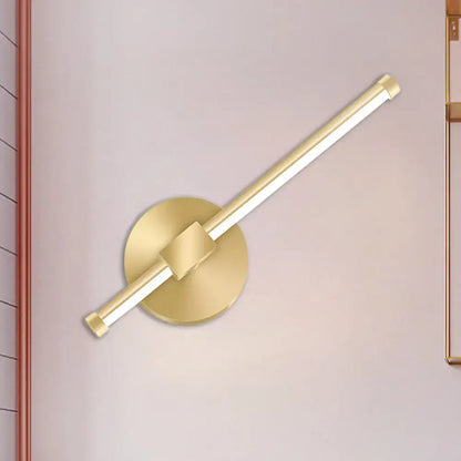 Gold tube wall sconce by Decorbites with round backplate and diagonal gold tube on Tampa Home & Garden Store