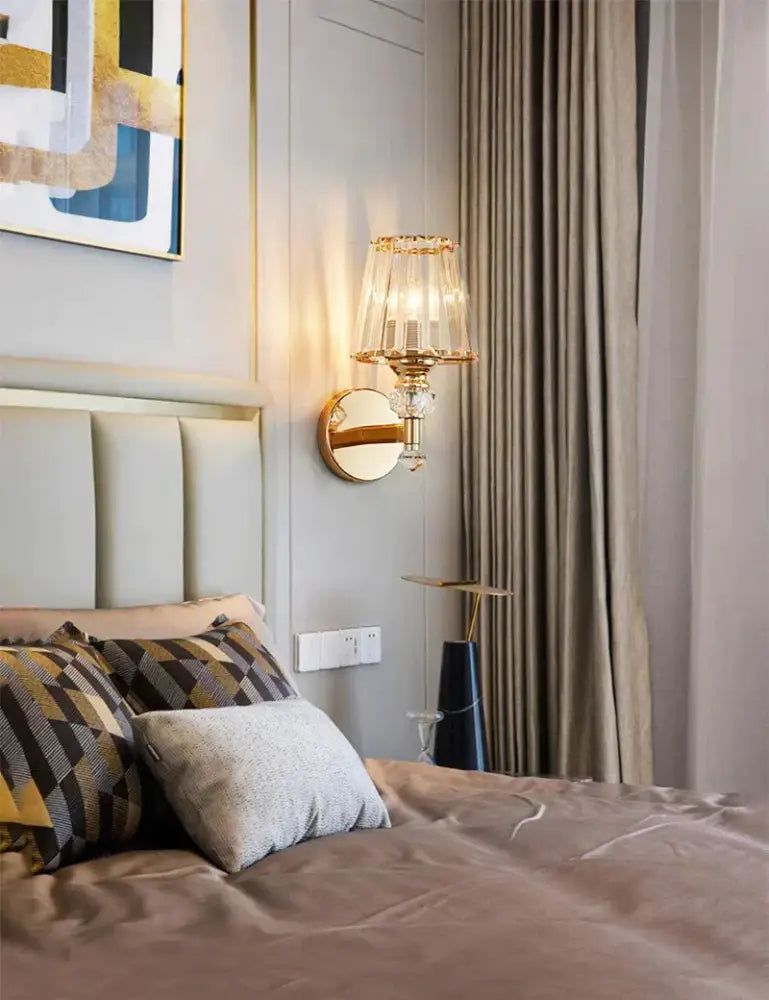 Gold Crystal Wall Lamp by Decorbites with crystal shade and gold hardware beside bed on Tampa Home & Garden Store