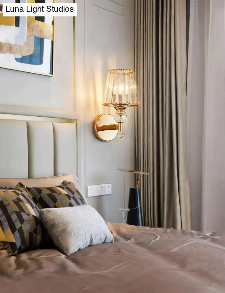 Gold finish wall lamp with clear glass shade and crystal accents for bedside lighting on Tampa Home & Garden Store