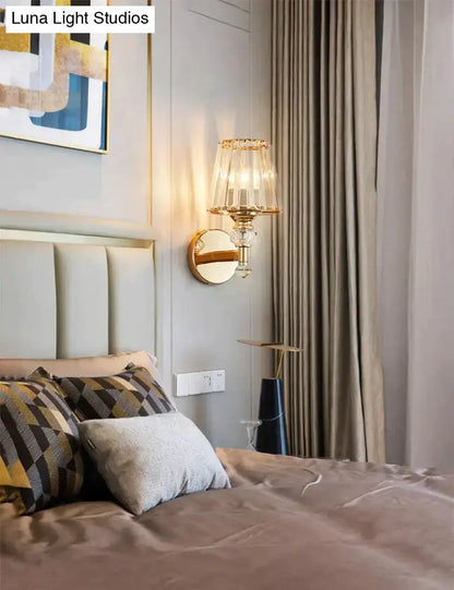 Gold finish wall lamp with clear glass shade and crystal accents for bedside lighting on Tampa Home & Garden Store