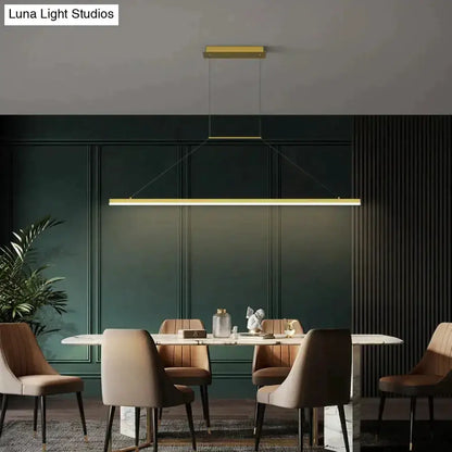 LED pendant light by Decorbites, gold bar fixture over dining table in paneled dining room on Tampa Home & Garden Store