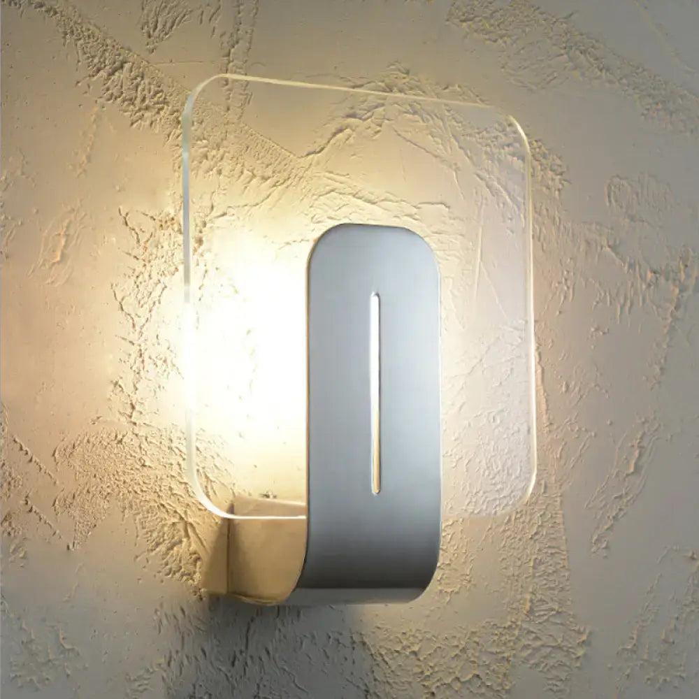 Nickel glass wall sconce with vertical metal centerpiece and soft glow backlit frame on Tampa Home & Garden Store