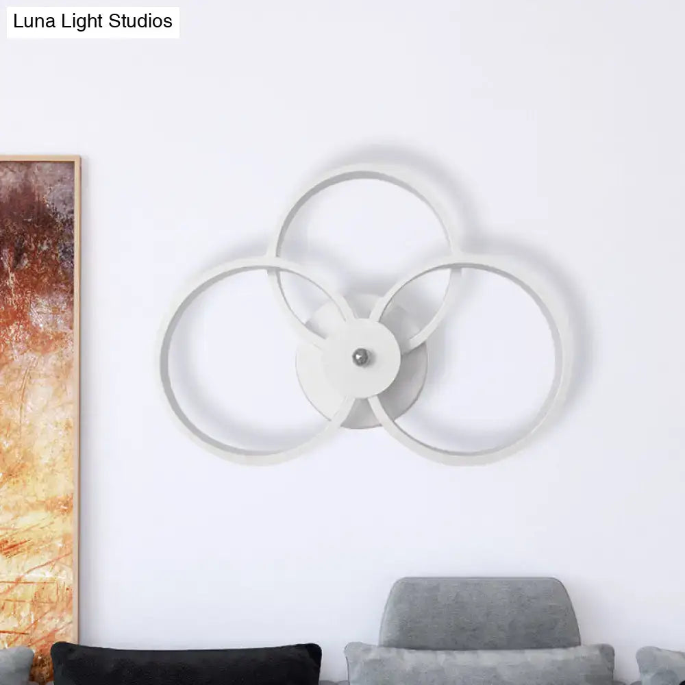 White metal 3-ring wall sconce with overlapping circular frames by Decorbites on Tampa Home & Garden Store