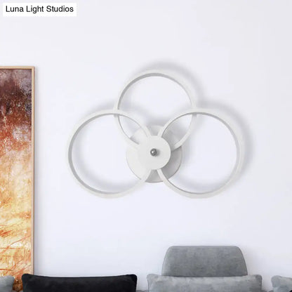 White metal 3-ring wall sconce with overlapping circular frames by Decorbites on Tampa Home & Garden Store