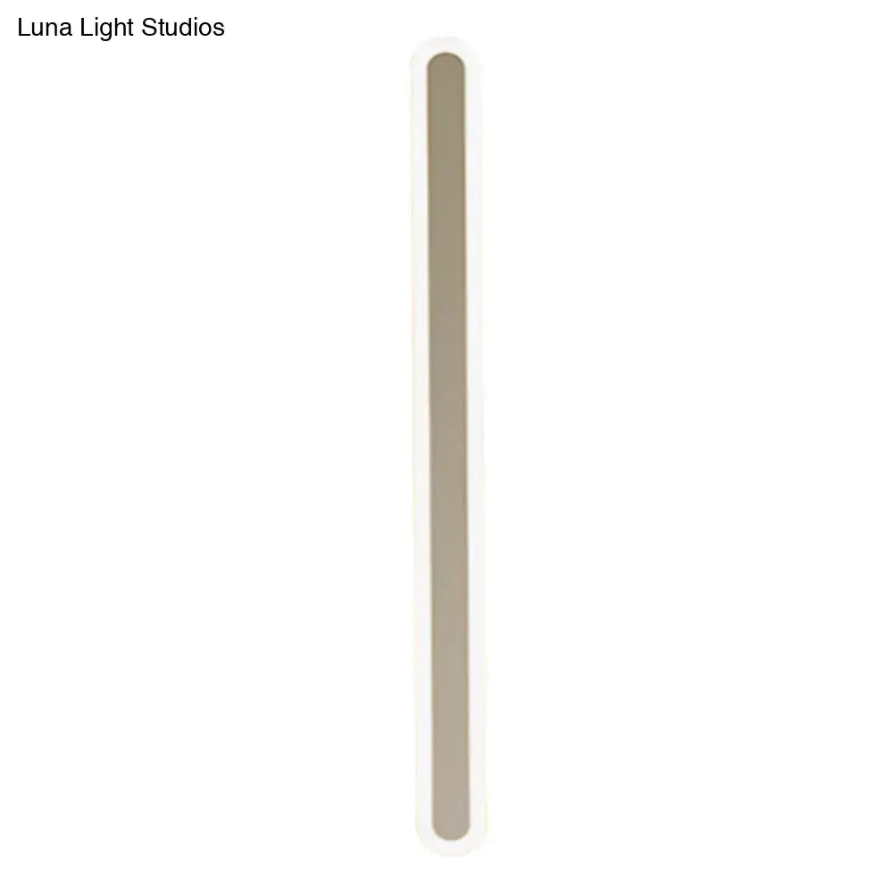 White acrylic wall sconce with a tall vertical light bar and rounded ends on Tampa Home & Garden Store