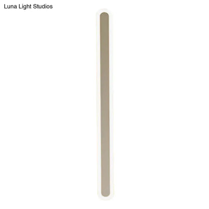 White acrylic wall sconce with a tall vertical light bar and rounded ends on Tampa Home & Garden Store