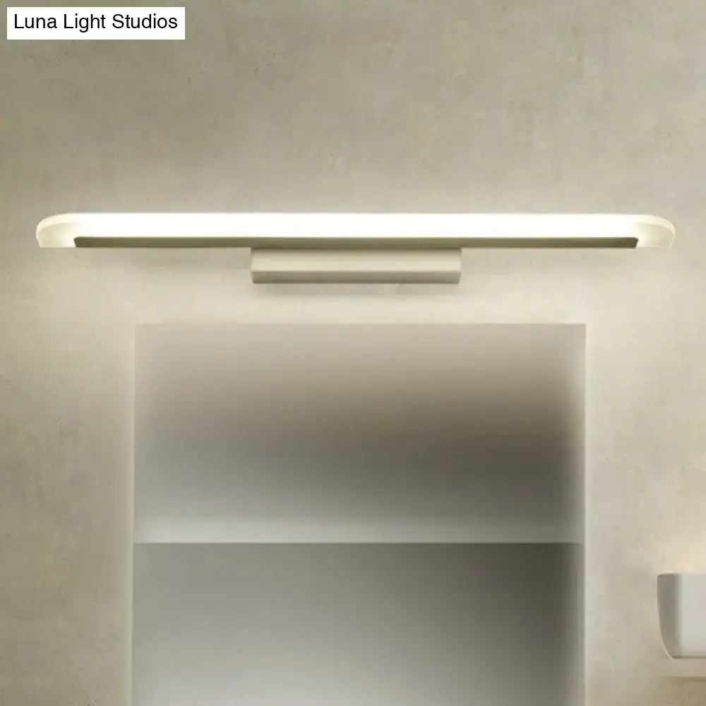 White LED vanity sconce by Decorbites with slim bar and rounded ends, wall-mounted over mirror on Tampa Home & Garden Store