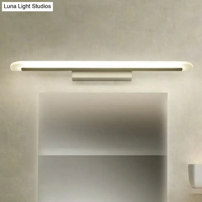 White LED vanity sconce by Decorbites with slim bar and rounded ends, wall-mounted over mirror on Tampa Home & Garden Store