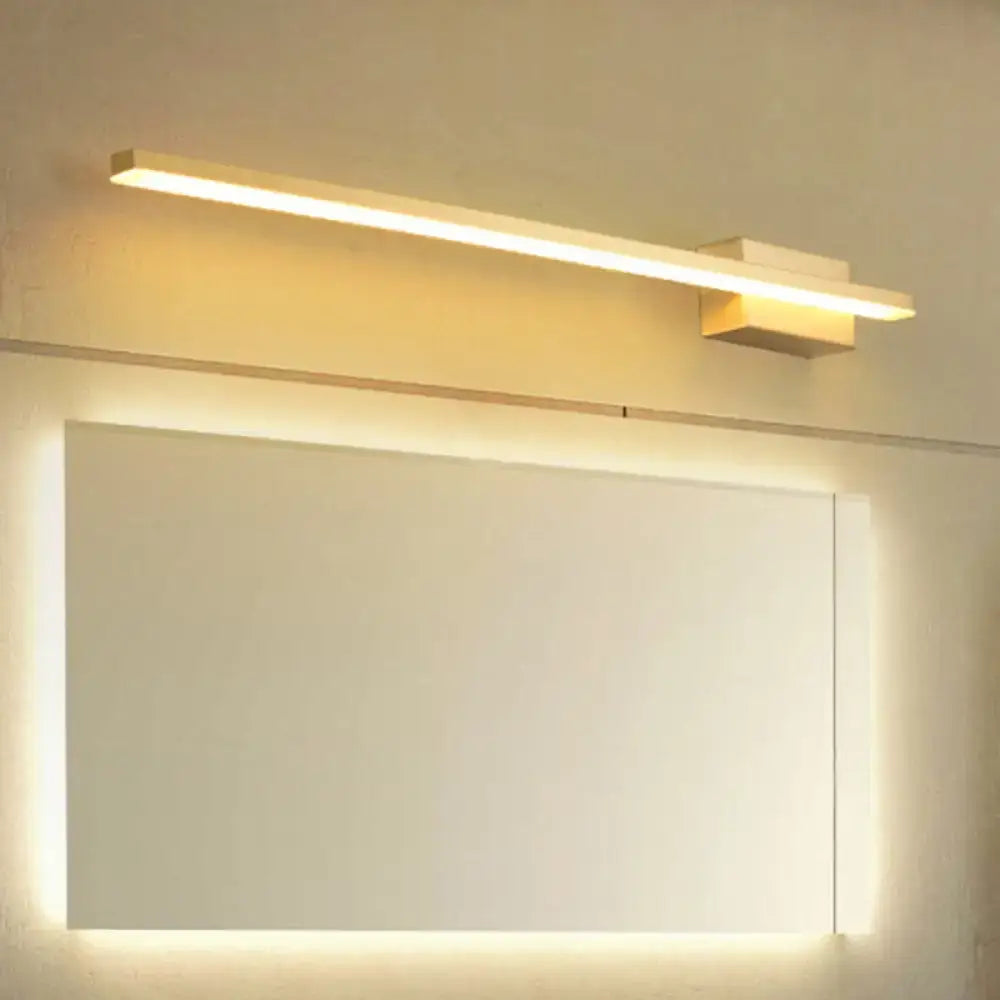 Gold LED Vanity Light by Decorbites, slim gold bar over a backlit mirror with warm glow on Tampa Home & Garden Store