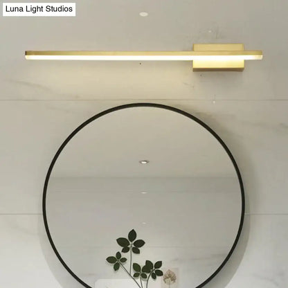 Gold LED vanity light with a slim bar mounted above a round black-framed mirror on a light wall on Tampa Home & Garden Store