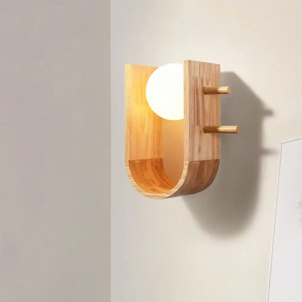 Wooden Modern Wall Sconce by Decorbites with curved wooden frame and white globe bulb on wall on Tampa Home & Garden Store