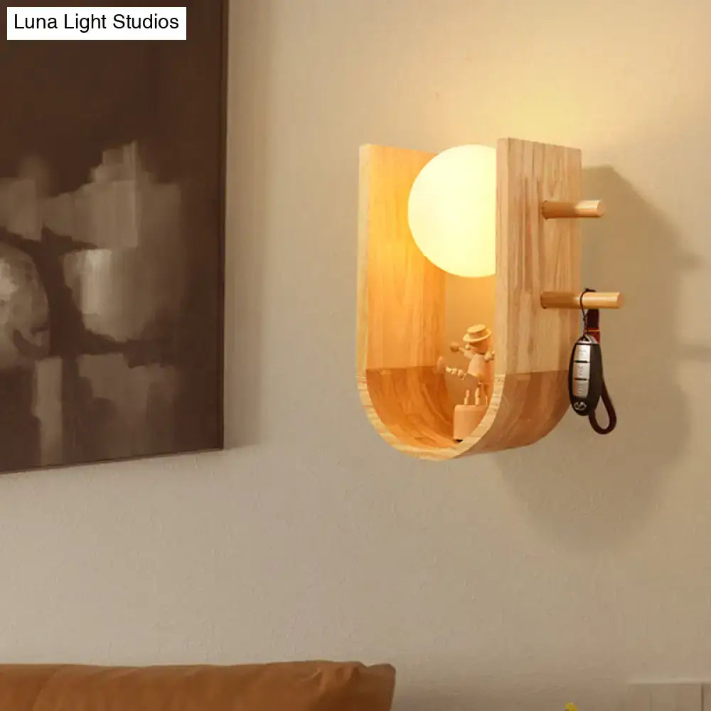 Wooden modern wall sconce with curved wood shelf and glowing globe bulb on Tampa Home & Garden Store