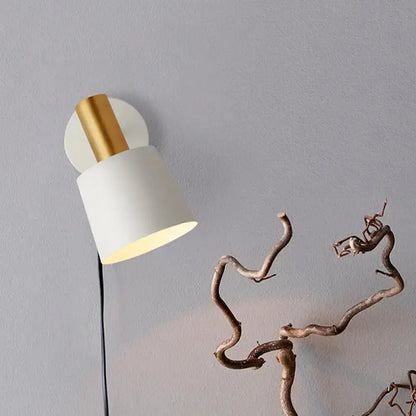 Modern metal drum wall sconce with white shade and gold mount on Tampa Home & Garden Store