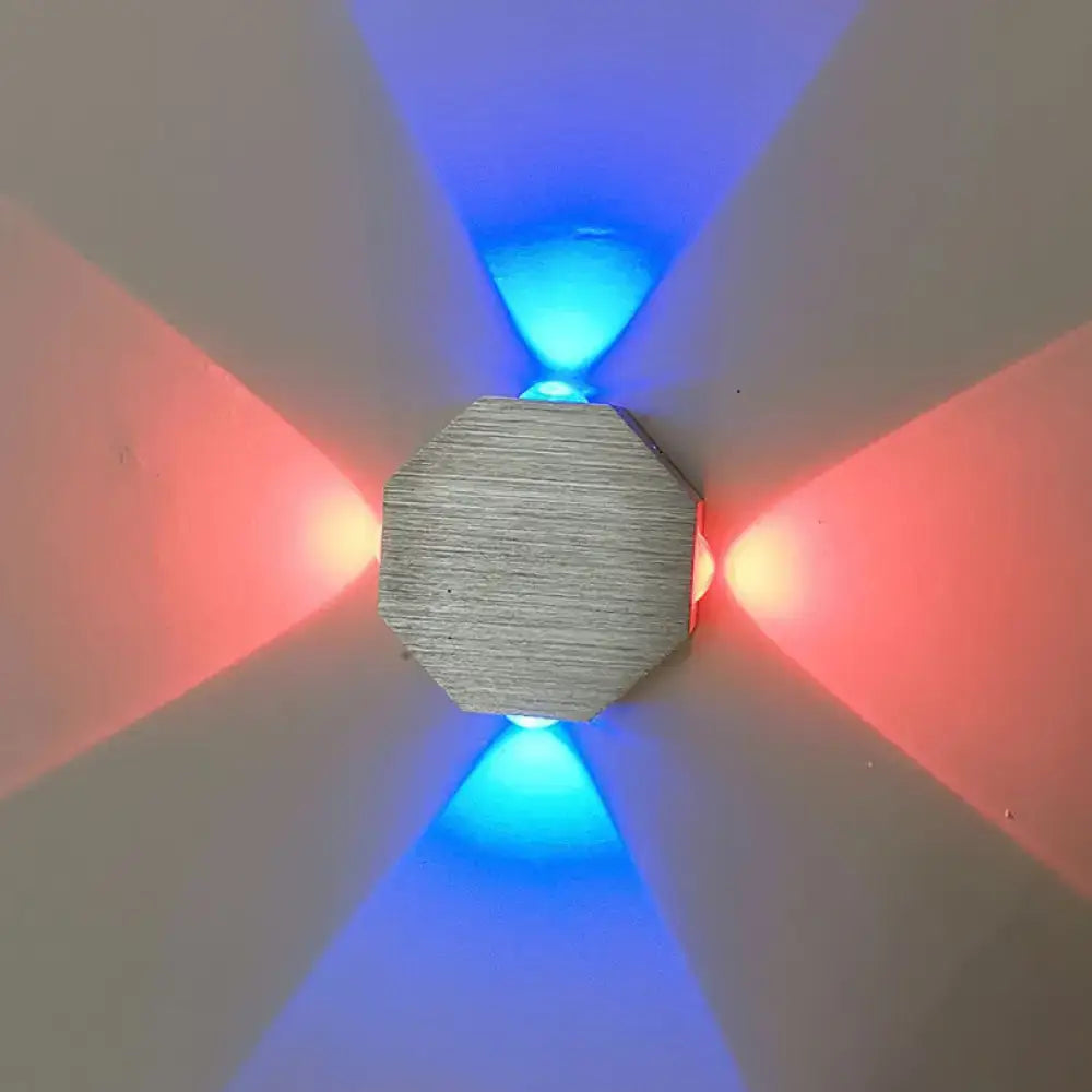 Nickel octagonal wall sconce by Decorbites casting blue and red ambient light on wall on Tampa Home & Garden Store