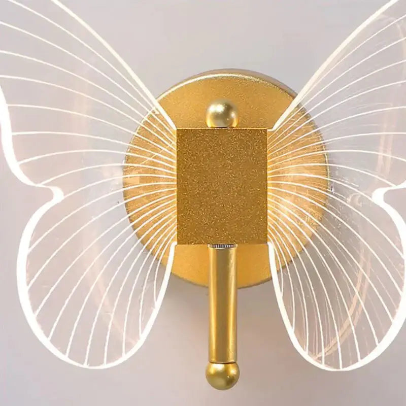Gold butterfly wall lamp Decorbites with gold body and wing panels on circular backplate on Tampa Home & Garden Store