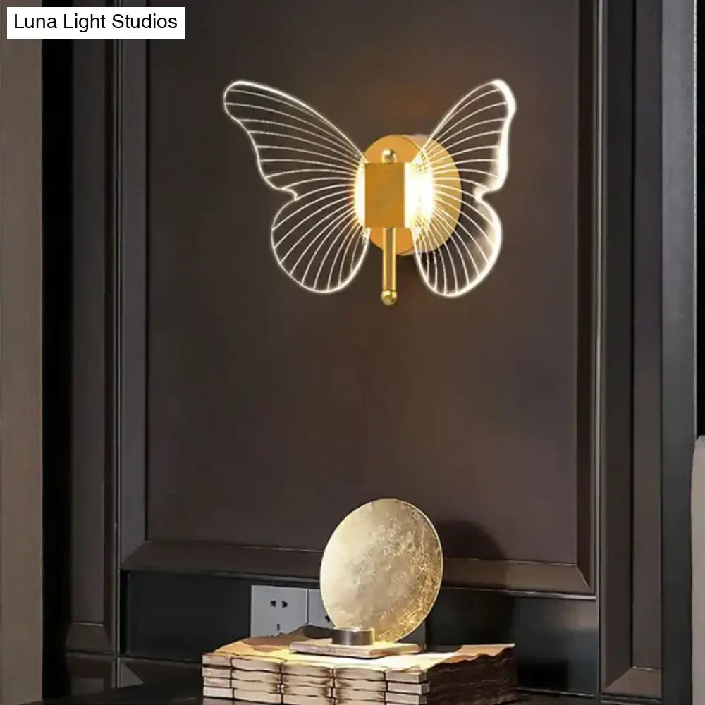 Gold Butterfly Wall Lamp by Decorbites with wire butterfly wings on dark wall on Tampa Home & Garden Store