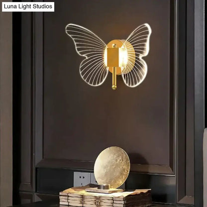 Gold Butterfly Wall Lamp by Decorbites with wire butterfly wings on dark wall on Tampa Home & Garden Store