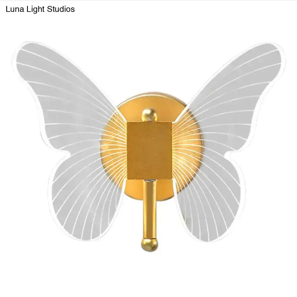 Gold butterfly wall lamp by Decorbites with gold metal body and gray translucent wings on wall on Tampa Home & Garden Store