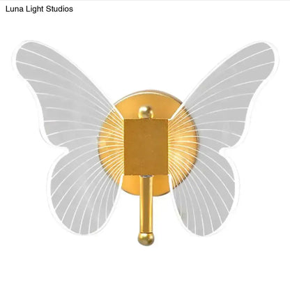 Gold butterfly wall lamp by Decorbites with gold metal body and gray translucent wings on wall on Tampa Home & Garden Store