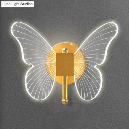 Gold butterfly wall lamp by Decorbites with illuminated white wings and gold body on Tampa Home & Garden Store
