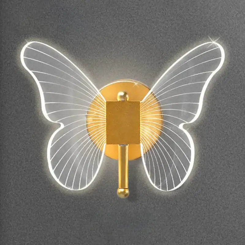 Gold butterfly wall lamp Decorbites with illuminated white wings and gold backplate on Tampa Home & Garden Store