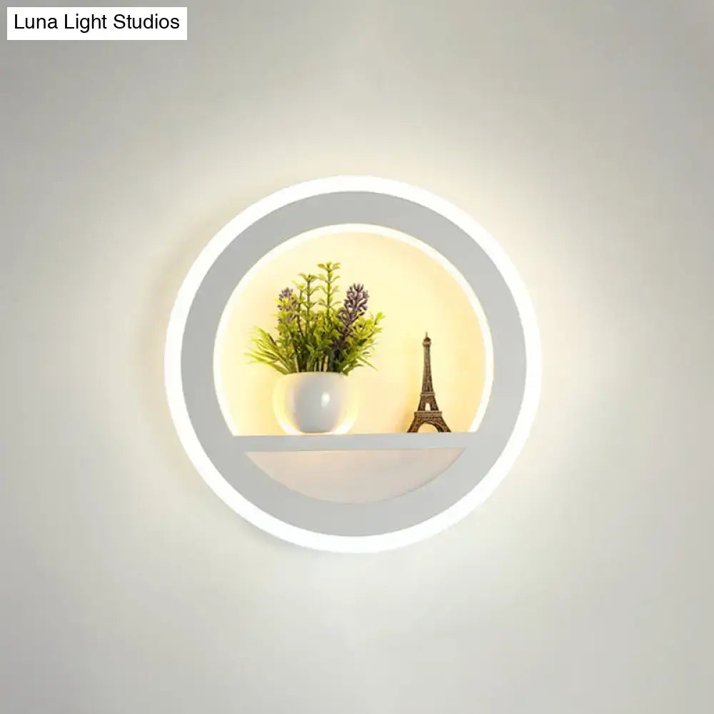 Black acrylic built-in shelf sconce with circular LED ring, plant and Eiffel Tower decor on Tampa Home & Garden Store