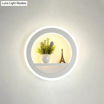 Black acrylic built-in shelf sconce with circular LED ring, plant and Eiffel Tower decor on Tampa Home & Garden Store