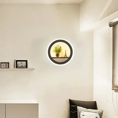Black acrylic built-in shelf wall sconce with circular LED ring by Decorbites; plant display on Tampa Home & Garden Store