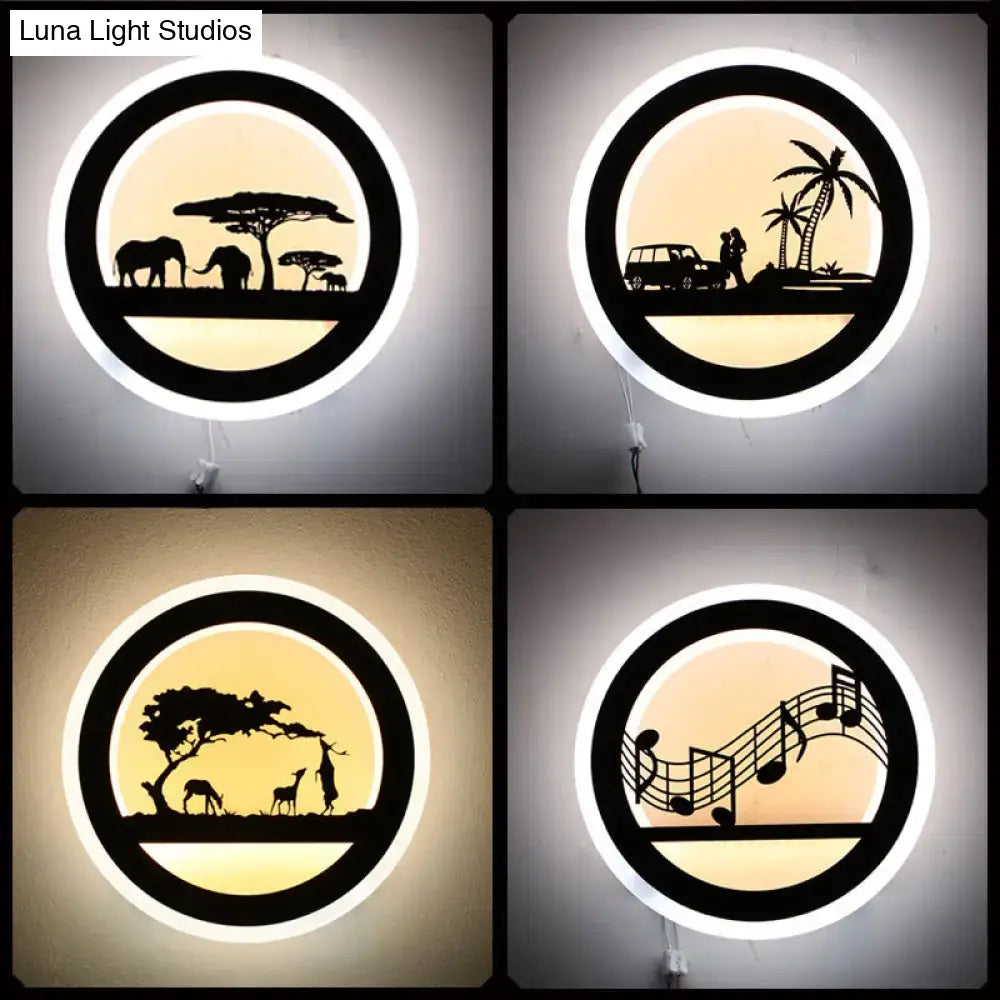 Black acrylic round built-in shelf wall sconce with warm backlit silhouettes elephants, couple by car, giraffes on Tampa Home & Garden Store