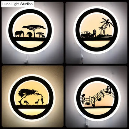 Black acrylic round built-in shelf wall sconce with warm backlit silhouettes elephants, couple by car, giraffes on Tampa Home & Garden Store