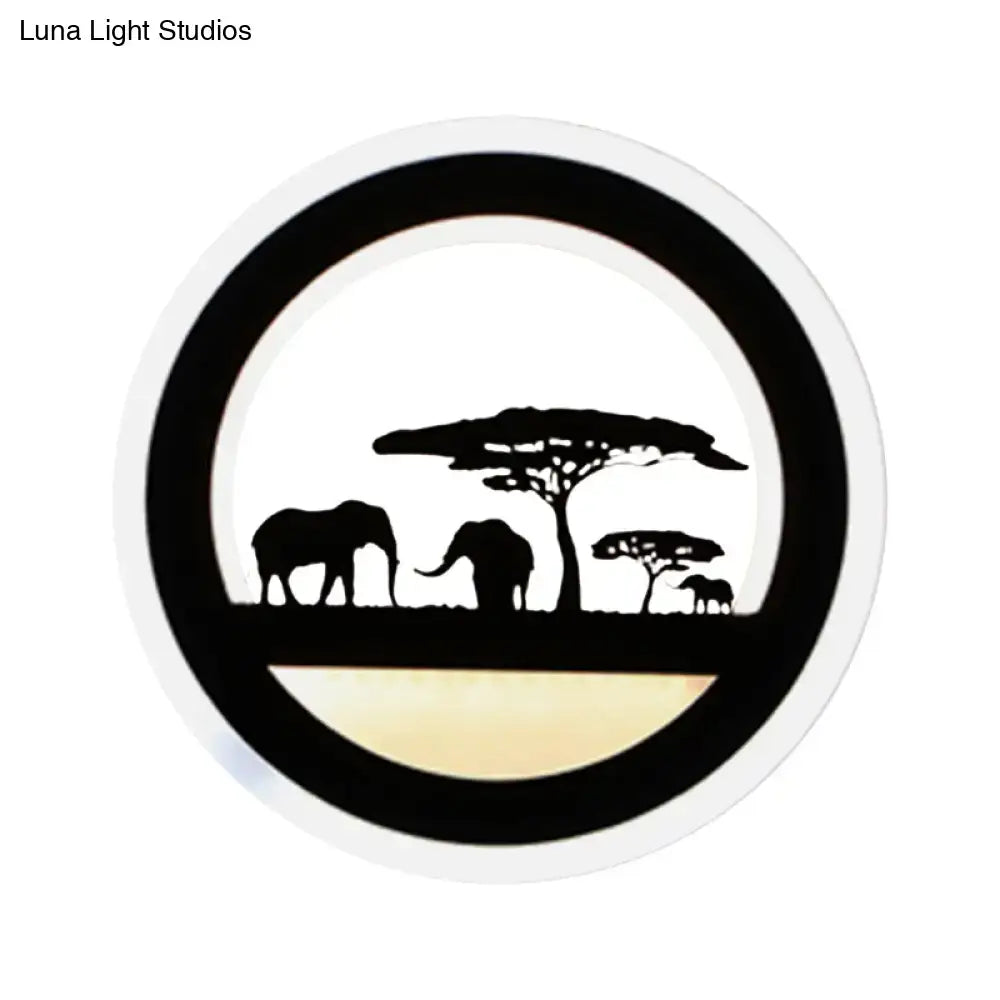 Black acrylic circular shelf wall sconce with safari elephant silhouettes and trees, warm glow on Tampa Home & Garden Store