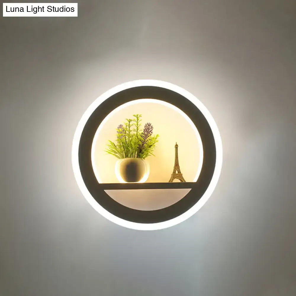 Black acrylic built-in shelf wall sconce with circular LED halo, plant and Eiffel Tower on Tampa Home & Garden Store