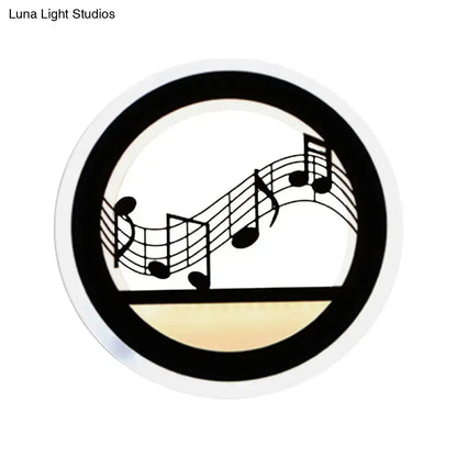 Black acrylic built-in shelf wall sconce with round frame and music note motif on Tampa Home & Garden Store
