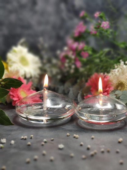 Stevvex round glass oil candle pair with flickering flames on clear domed bowls among flowers on Tampa Home & Garden Store