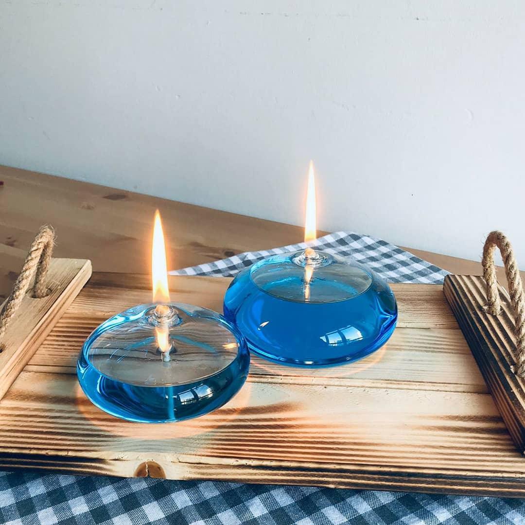 Stevvex round blue glass oil candles pair lit on a wooden tray with blue checkered cloth on Tampa Home & Garden Store