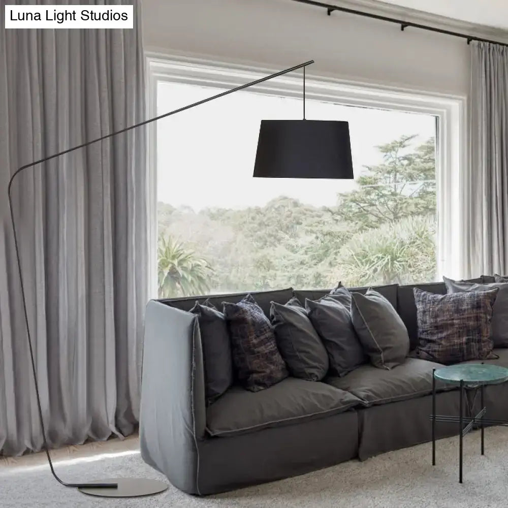 Olive upholstered armchair in a living room with a gray sofa and black arc floor lamp on Tampa Home & Garden Store