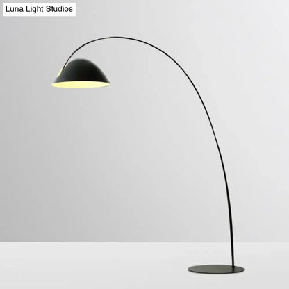 Arc floor lamp with black curved stem and dome shade, warm downlight, round base on Tampa Home & Garden Store